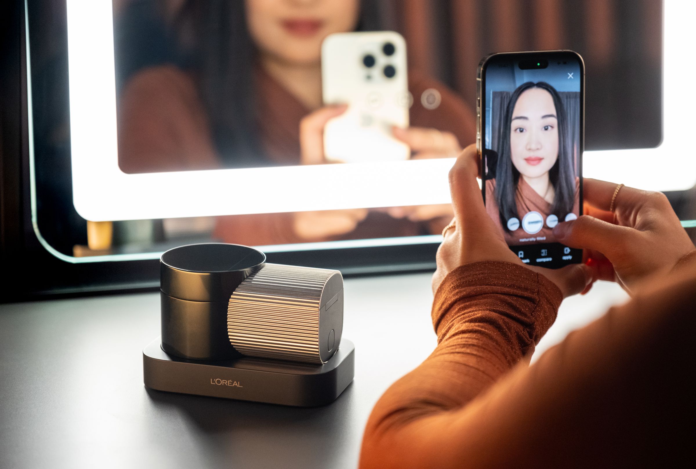 Woman looks at herself in AR using Brow Magic app