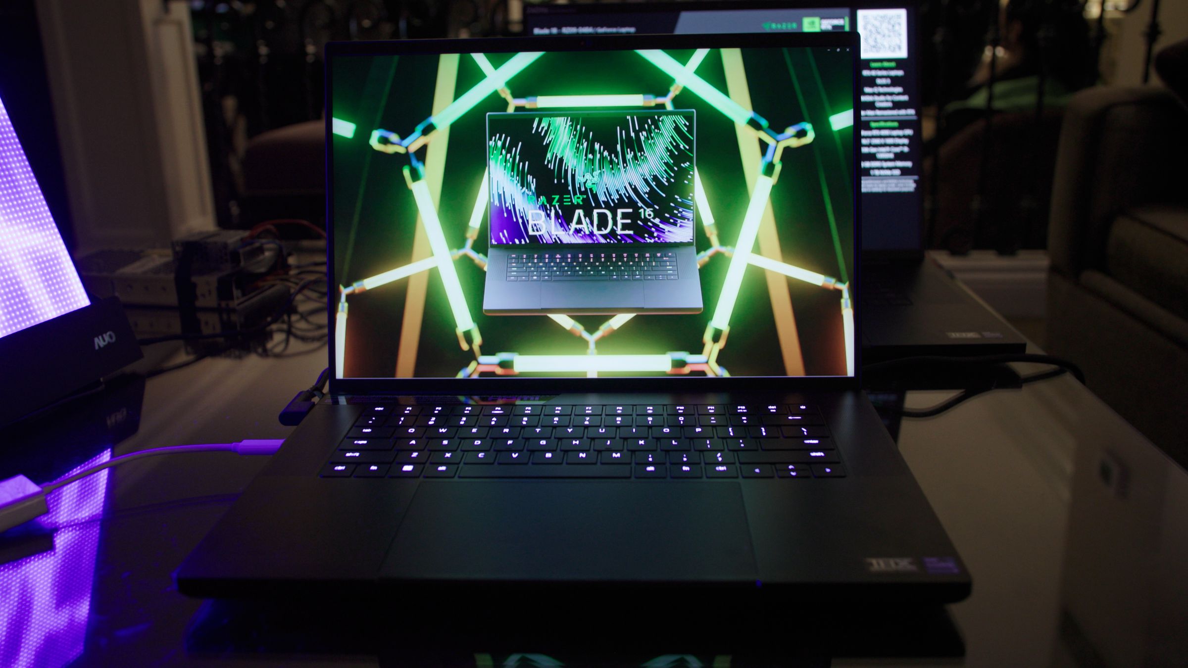 The Razer Blade 16 displaying a picture of itself over a neon grid.